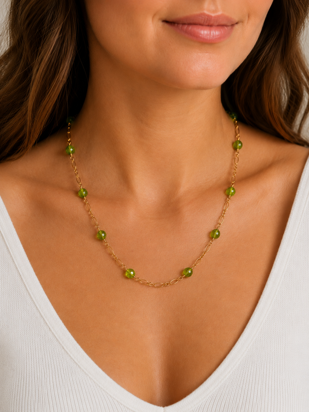 Necklace with green beads worn by a person