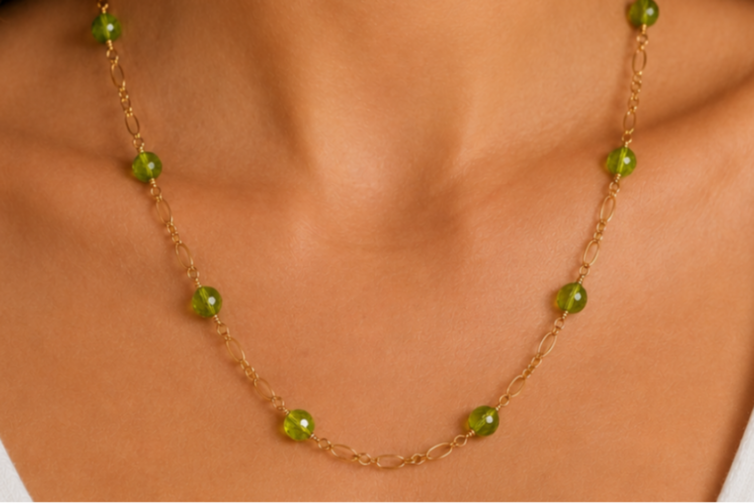Necklace with green beads worn by a person