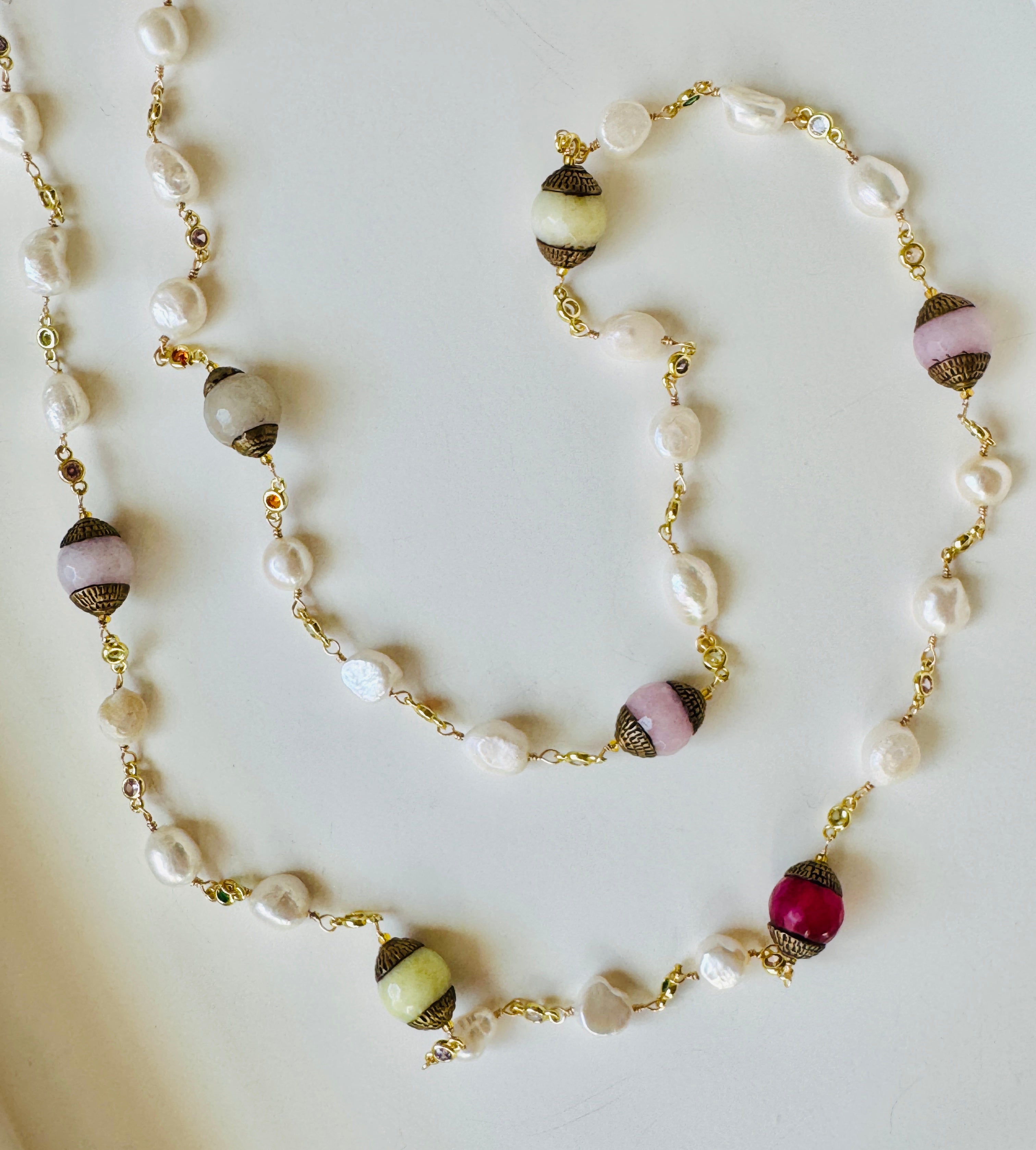 Pearl necklace with multicolored beads on a light background