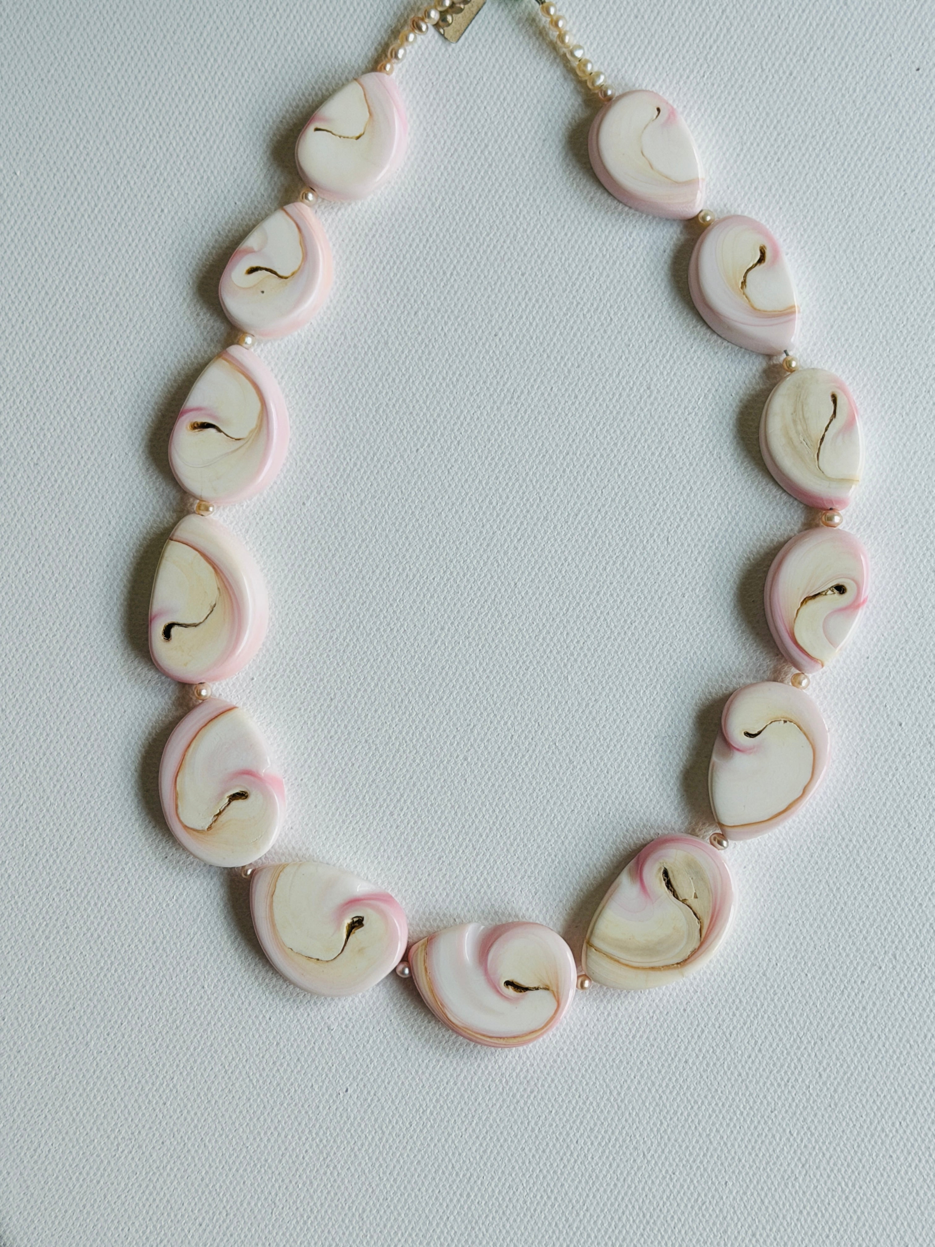 Slices of Lambi / Queen Conch Shell Necklace on white background